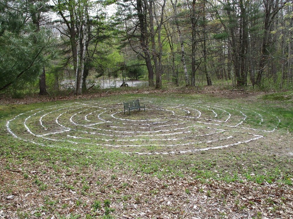 The sand outline of the labyrinth with a bench in the middle