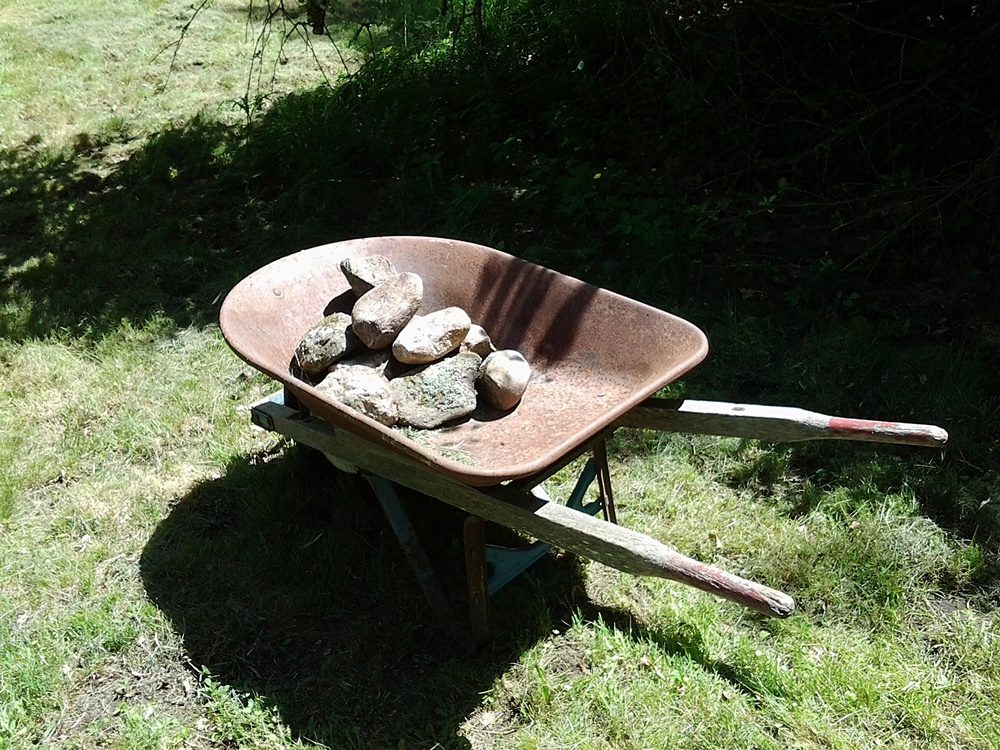 Rocks inside of a wheelbarrow