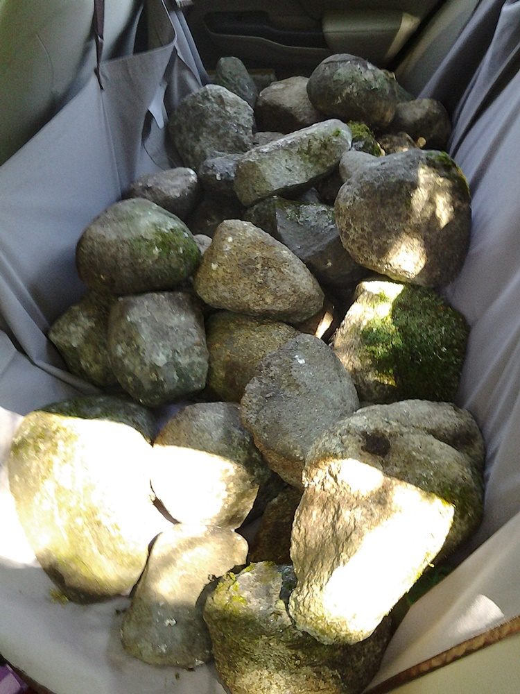A backseat of a car full of rocks for the labyrinth