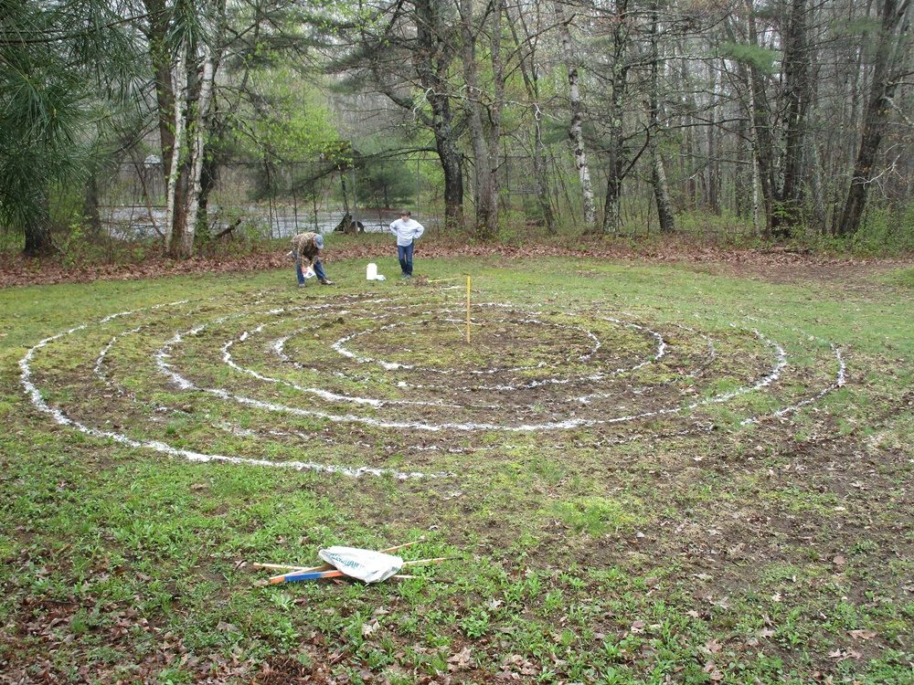 Two people taking measurements for the labyrinth