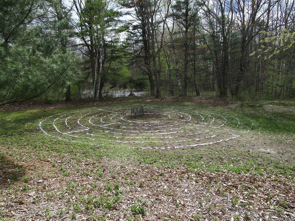 The sand outline of the labyrinth with a bench in the middle
