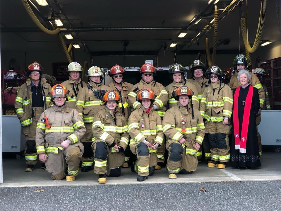 Group photo of fire department and Pastor Kate